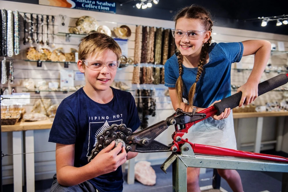 Visitor holding a freshly cracked geode revealing crystals inside